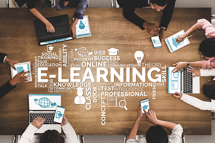 group of people sitting around a desk, A word map is also showing with words like e-learning, knowledge, information.