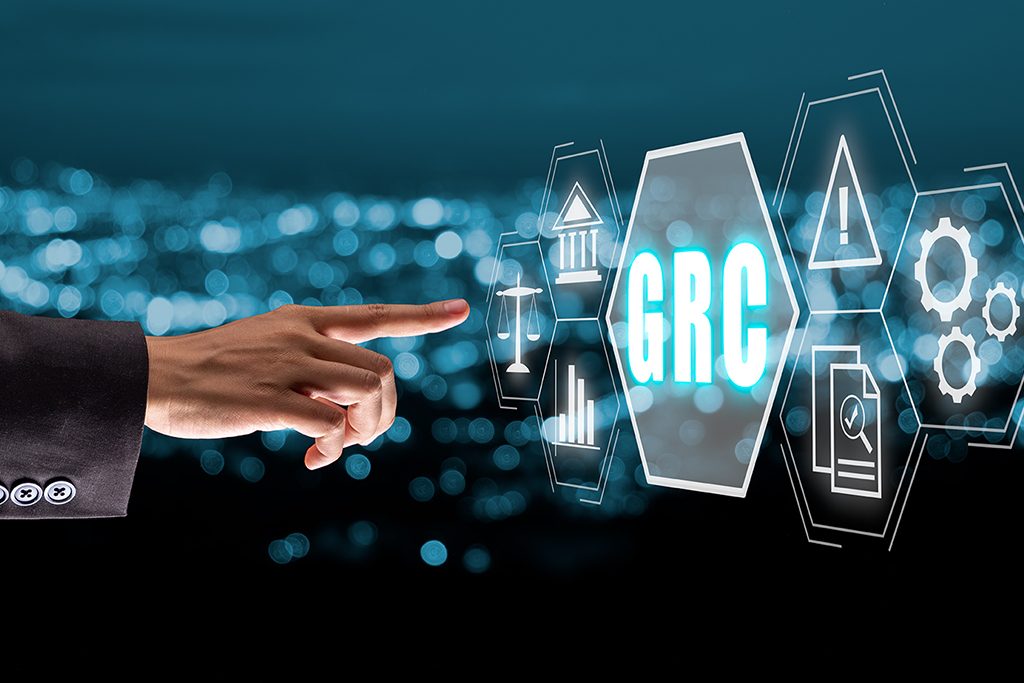 GRC, Governance Risk and Compliance concept, Business hand touching Governance Risk and Compliance icon on virtual screen.